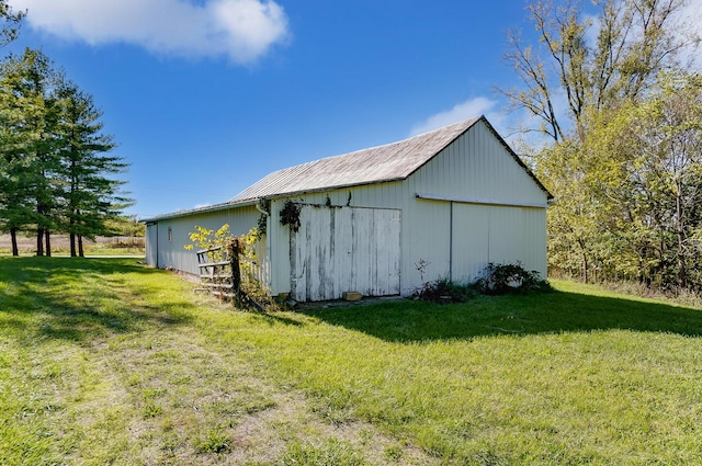 view of outbuilding featuring a lawn