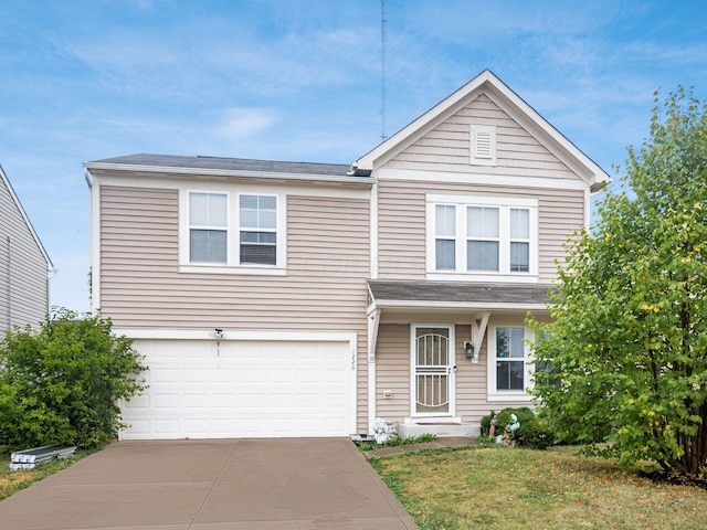 view of front of property with a garage and a front lawn