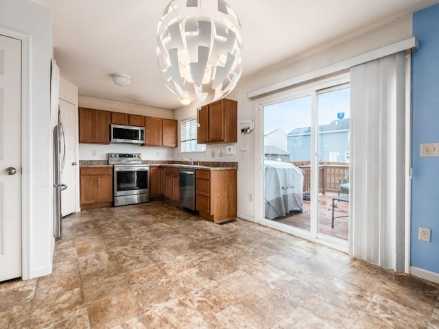 kitchen with sink, hanging light fixtures, a chandelier, and appliances with stainless steel finishes