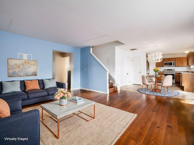 living room with a chandelier and hardwood / wood-style flooring