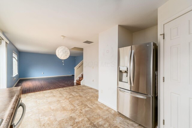 kitchen featuring dishwasher, baseboards, hanging light fixtures, visible vents, and stainless steel refrigerator with ice dispenser