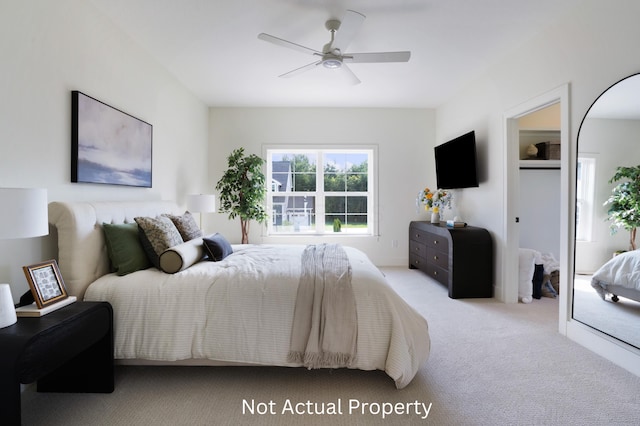 bedroom with light carpet and ceiling fan