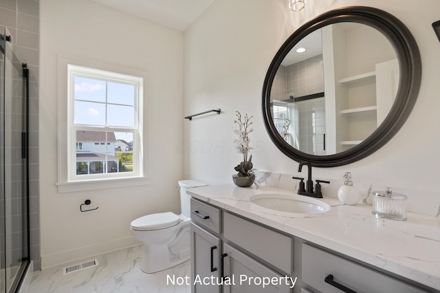 bathroom featuring vanity, toilet, and an enclosed shower