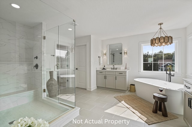 bathroom featuring vanity, tile patterned floors, and shower with separate bathtub