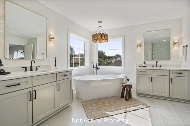 bathroom with tile patterned flooring, vanity, and plus walk in shower