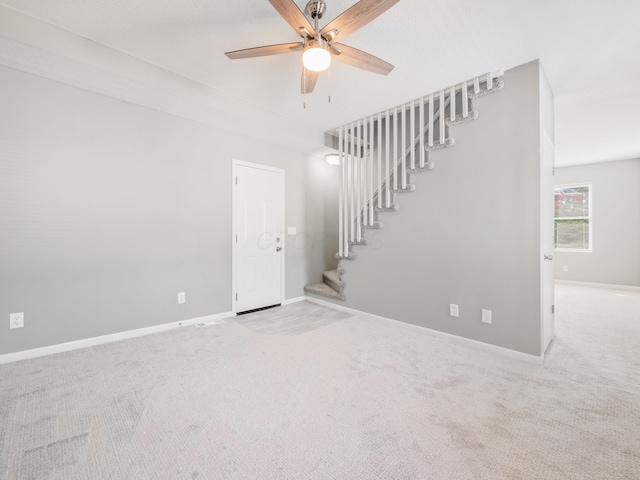 spare room with carpet flooring and ceiling fan