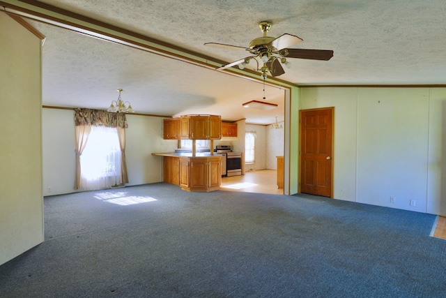 unfurnished living room with ceiling fan with notable chandelier, a textured ceiling, light colored carpet, and ornamental molding