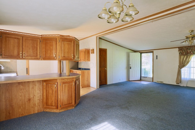 kitchen with kitchen peninsula, ceiling fan with notable chandelier, light colored carpet, and ornamental molding