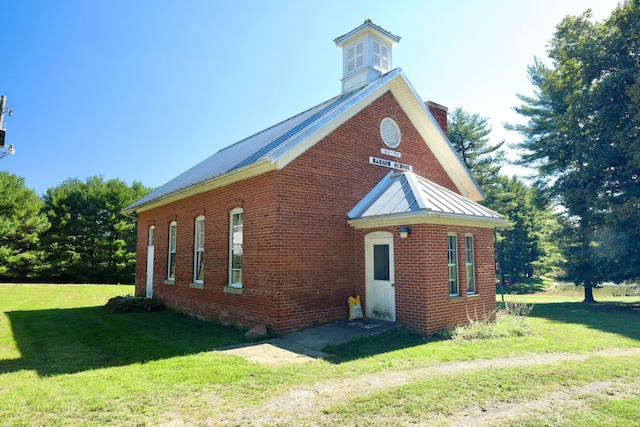 view of property exterior with a lawn