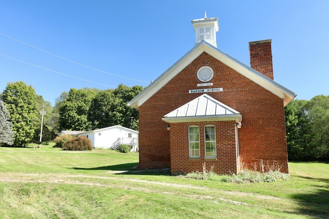 view of property exterior with a lawn