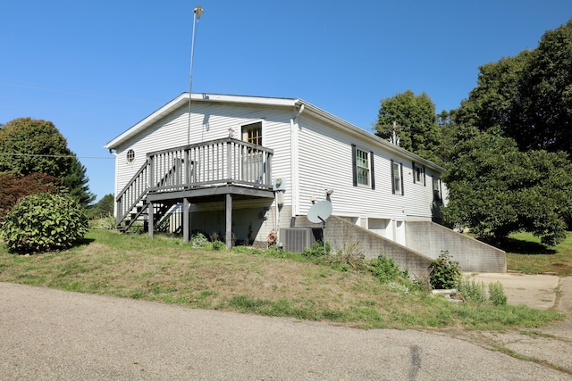 view of home's exterior featuring central AC unit and a wooden deck