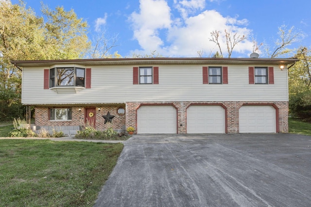 view of front of house with a front yard and a garage