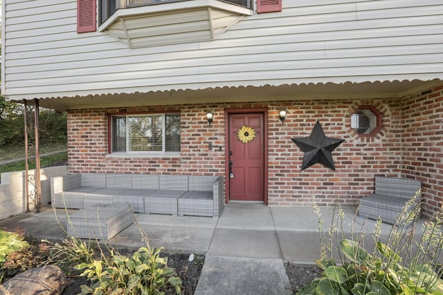 view of exterior entry featuring an outdoor hangout area and a patio area