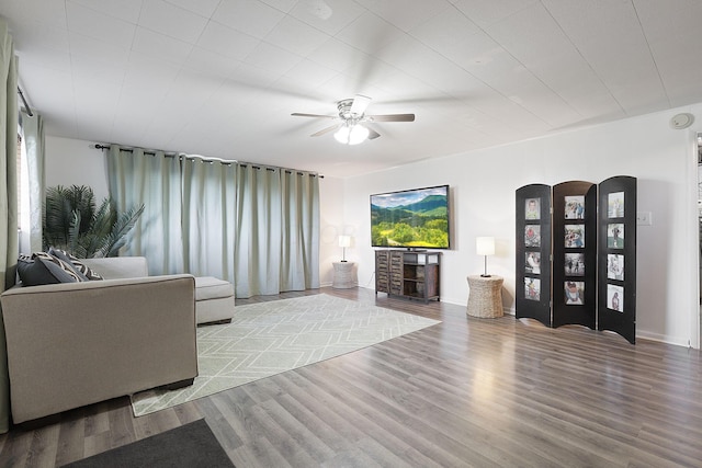 living room with ceiling fan and light hardwood / wood-style flooring