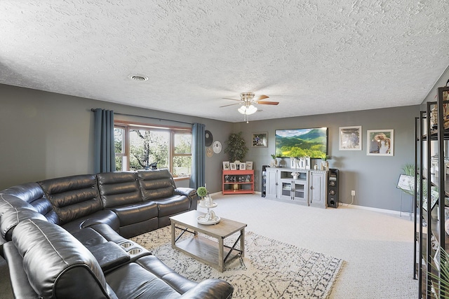 living room featuring a textured ceiling, ceiling fan, and carpet