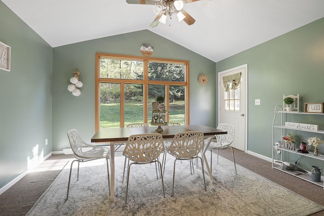 carpeted dining room featuring ceiling fan and lofted ceiling