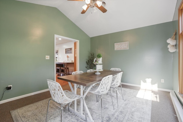 dining room featuring high vaulted ceiling, carpet flooring, and ceiling fan