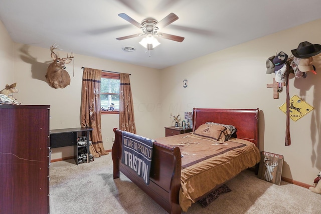 bedroom with ceiling fan and light carpet