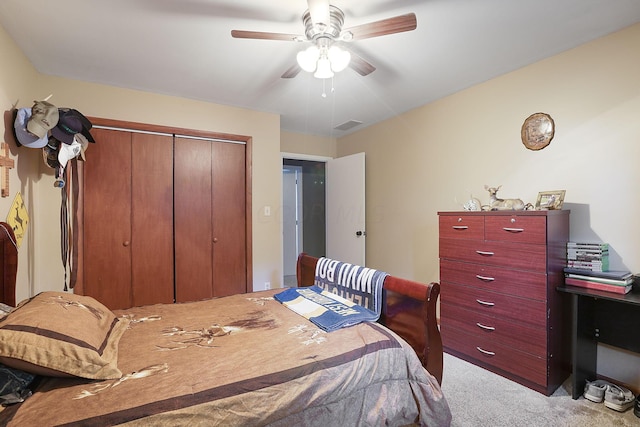 carpeted bedroom featuring a closet and ceiling fan