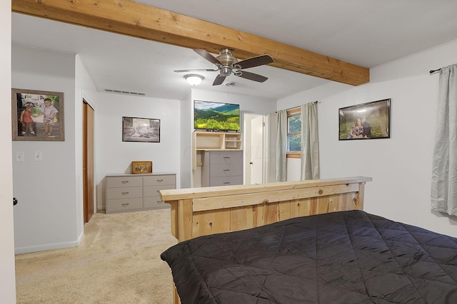 carpeted bedroom featuring ceiling fan and beamed ceiling