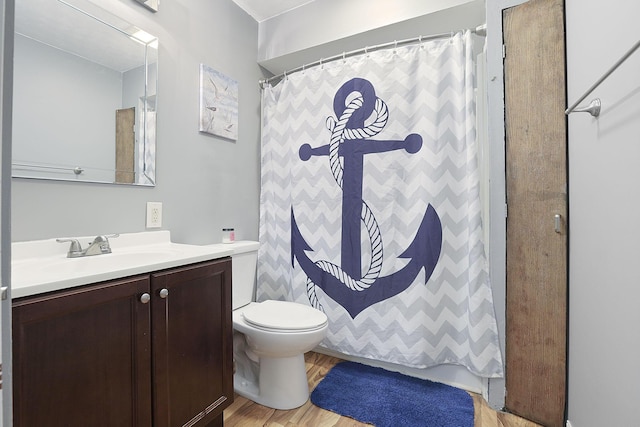 bathroom featuring curtained shower, toilet, vanity, and hardwood / wood-style flooring