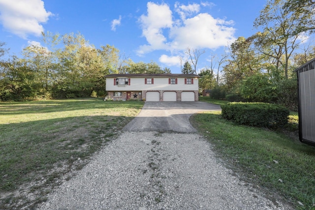 raised ranch featuring a front yard and a garage