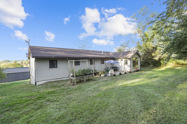 back of house with a lawn