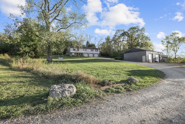 view of yard with a garage and an outdoor structure