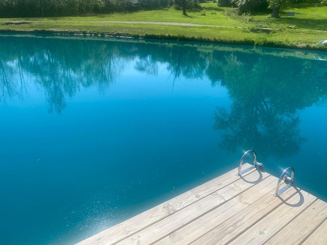 view of pool with a yard