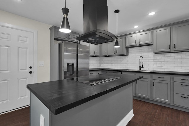 kitchen featuring island range hood, a center island, hanging light fixtures, and stainless steel refrigerator with ice dispenser