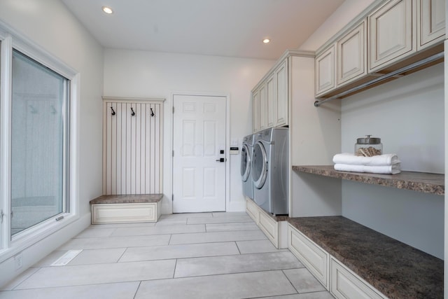 washroom with cabinets and washing machine and clothes dryer