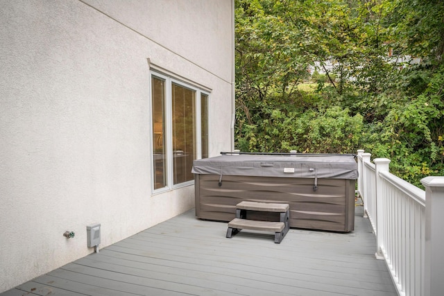 wooden terrace with a hot tub