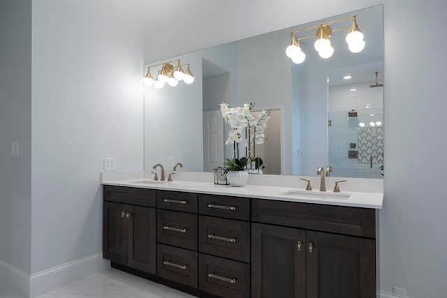 bathroom featuring tiled shower and vanity