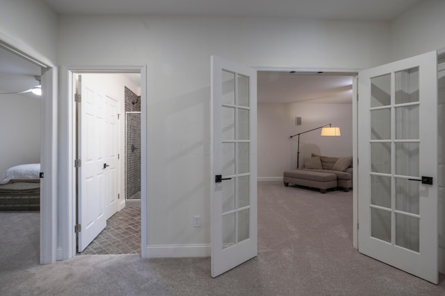 hallway with carpet and french doors