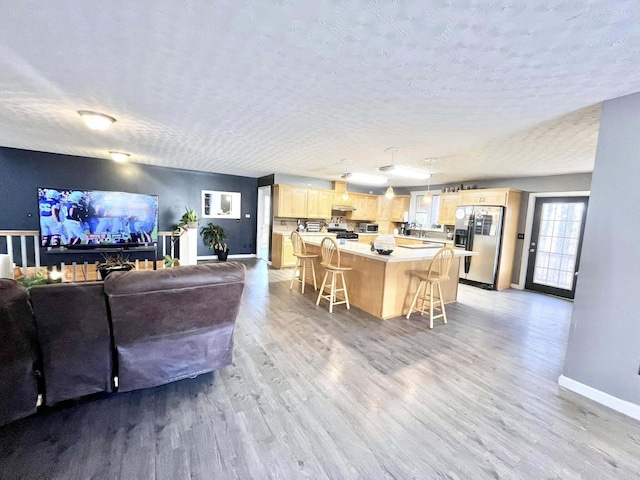 living room featuring a textured ceiling and light wood-type flooring