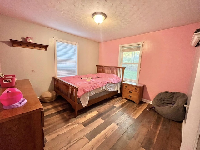 bedroom featuring wood-type flooring and a textured ceiling