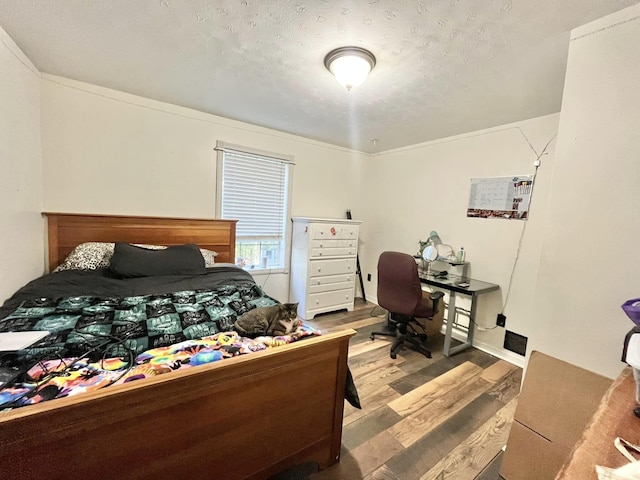 bedroom featuring a textured ceiling and hardwood / wood-style flooring