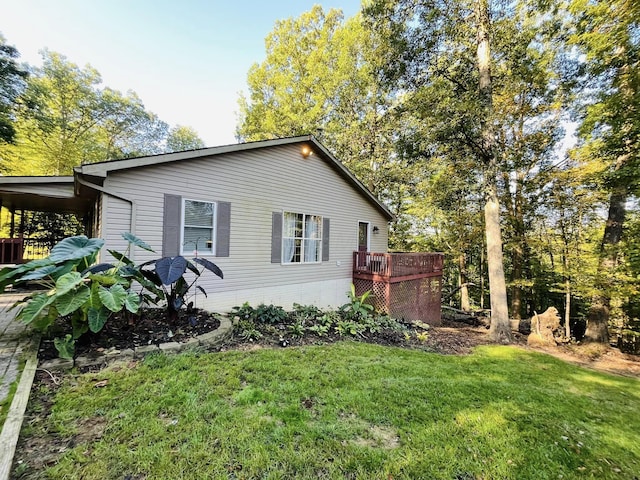 view of side of property with a yard and a deck