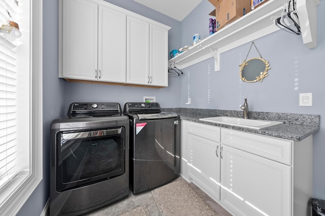 laundry room with cabinets, separate washer and dryer, sink, and light tile patterned floors