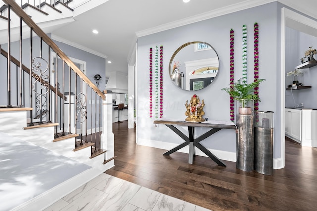 foyer entrance featuring hardwood / wood-style floors and ornamental molding