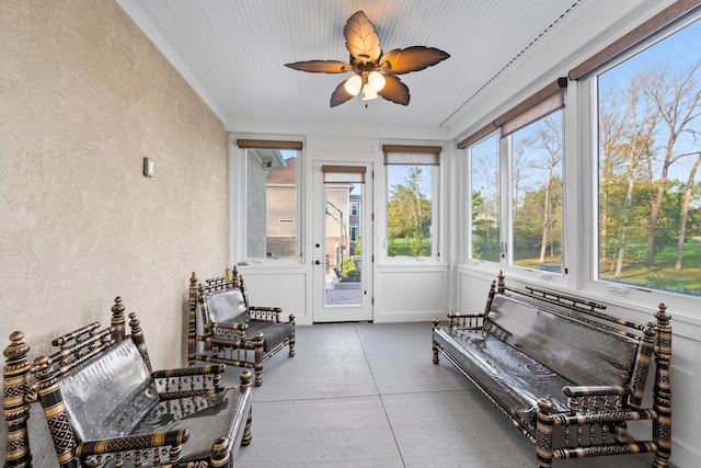 sunroom featuring ceiling fan