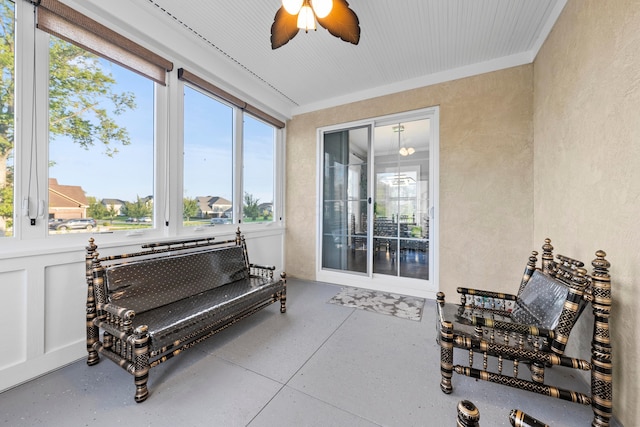 sunroom with a wealth of natural light and ceiling fan