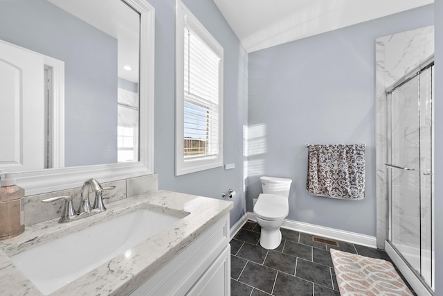 bathroom with tile patterned flooring, vanity, toilet, and a shower with door