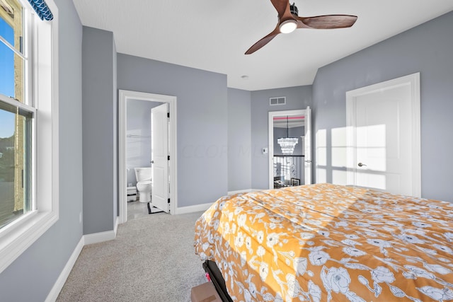 bedroom featuring connected bathroom, ceiling fan, and light colored carpet