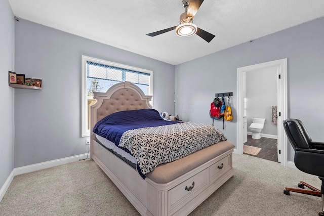 carpeted bedroom featuring ensuite bath and ceiling fan