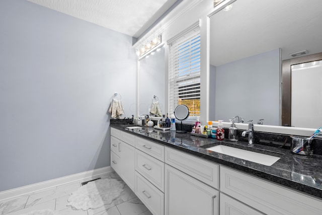 bathroom with a textured ceiling and vanity