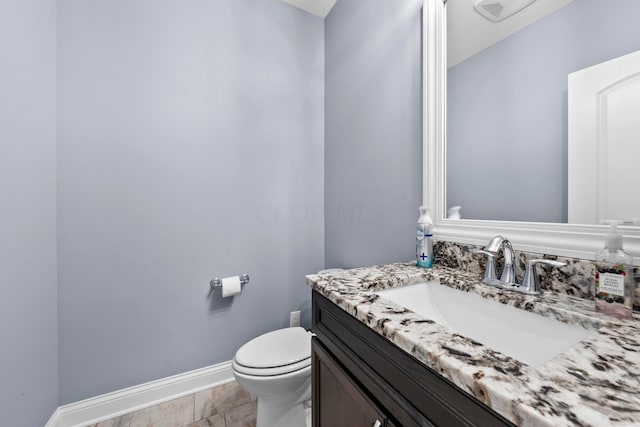 bathroom featuring tile patterned flooring, vanity, and toilet