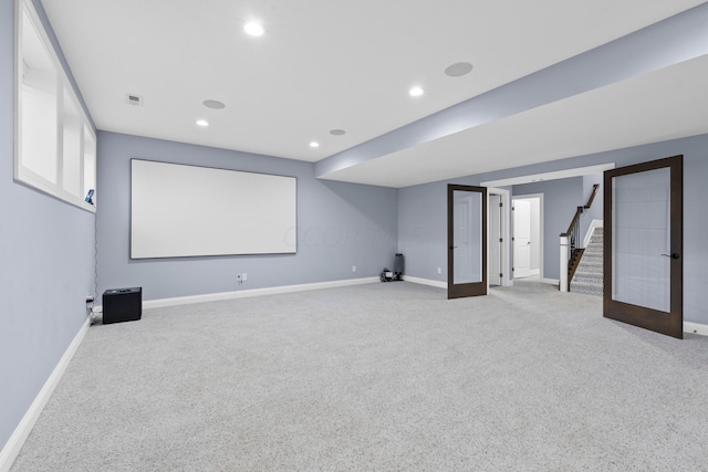 home theater room featuring carpet floors and french doors