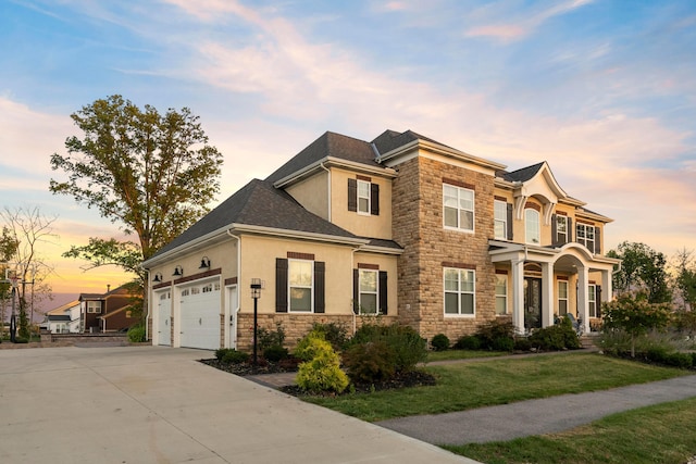 view of front of house with a garage and a yard