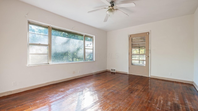 empty room featuring dark hardwood / wood-style flooring and ceiling fan